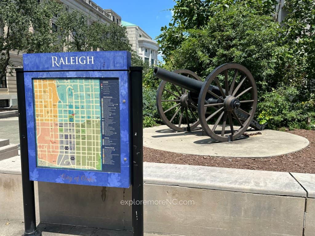 Map of Downtown Raleigh with a canon in the background