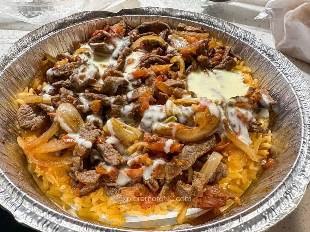 ACC Dish from Orale Taco, steak, rice, onions, cheese sause, peppers