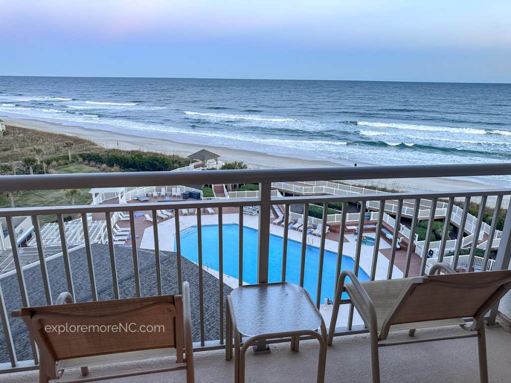 View from Balcony overlooking pool and ocean during the day at Holiday Inn Resort Lumina Wrightsville Beach
